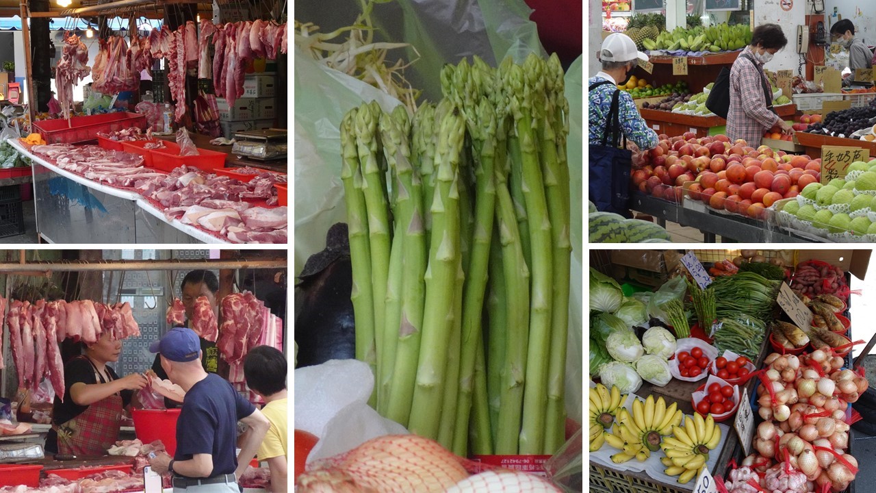 A group of people sitting at a fruit standDescription automatically generated